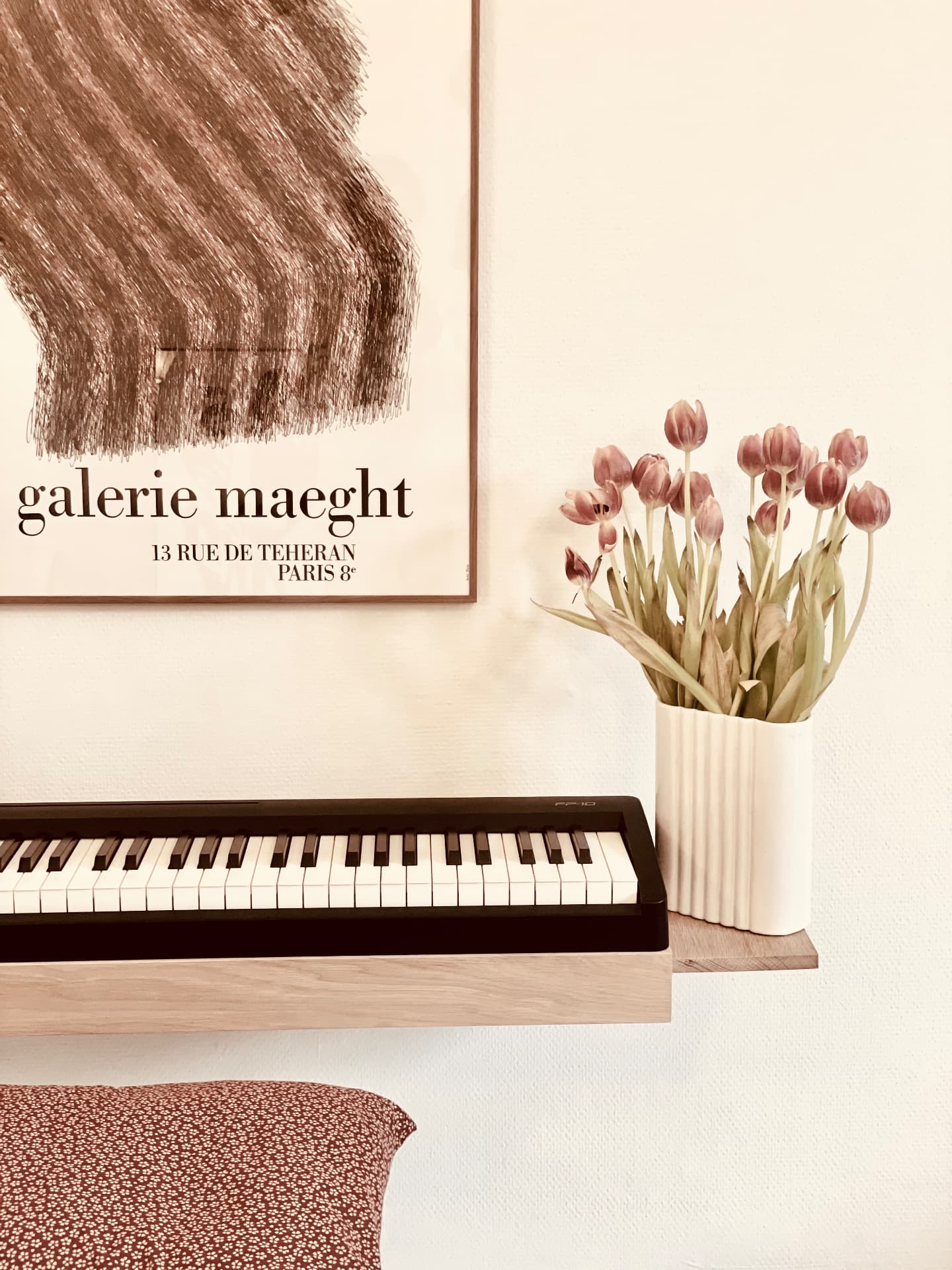 Solid oak Floating Piano Frame for the Roland FP-10 with side shelf and tulips beneath a gallery poster